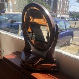 A mahogany swing toilet mirror