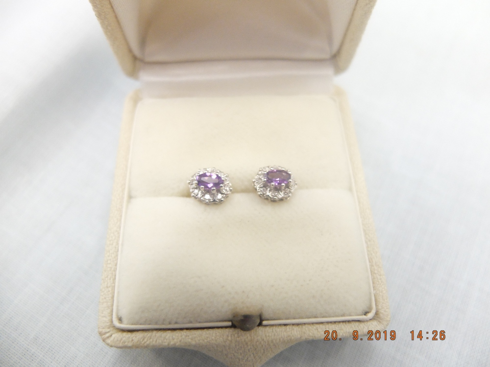 A pair of 9ct gold amethyst and diamond stud earrings