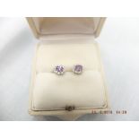 A pair of 9ct gold amethyst and diamond stud earrings