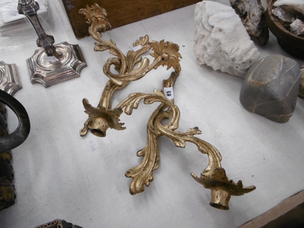 A pair of gilt two branch wall sconces