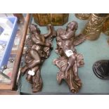 A pair of bronze wall cherubs