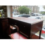 An inlaid mahogany kneehole desk