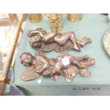 A pair of bronze wall cherubs