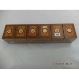 An inlaid wood six place watch box;