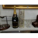 A Magnum bottle of champagne and a bottle of Moet