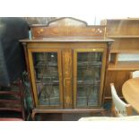 An inlaid mahogany art nouveau two door display cabinet