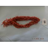 Two stick coral necklets and six strand coral bead necklace