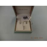 A pair of 18ct white gold and diamond earrings plus a matching pendant on white gold chain (9ct