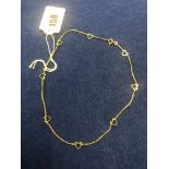 An 18ct gold heart chain