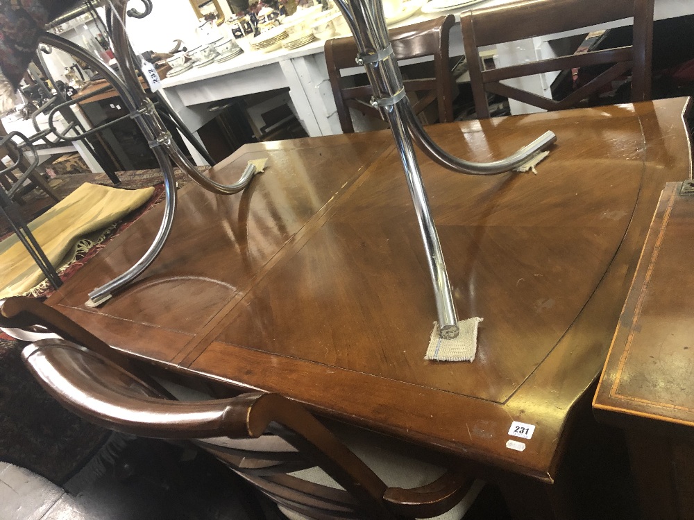 A contemporary extending dining table with two leaves,