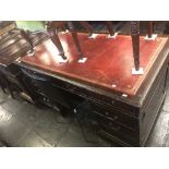 A pedestal desk red leather top