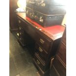 A mahogany pedestal desk with red leather insert