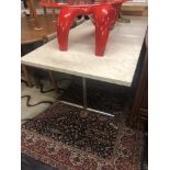 A marble top table on chrome base