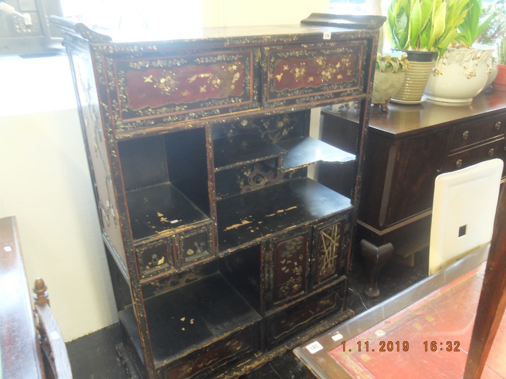 An oriental lacquered display cabinet