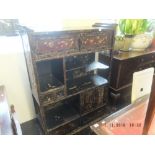 An oriental lacquered display cabinet