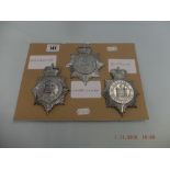 Three police constabulary helmet badges
