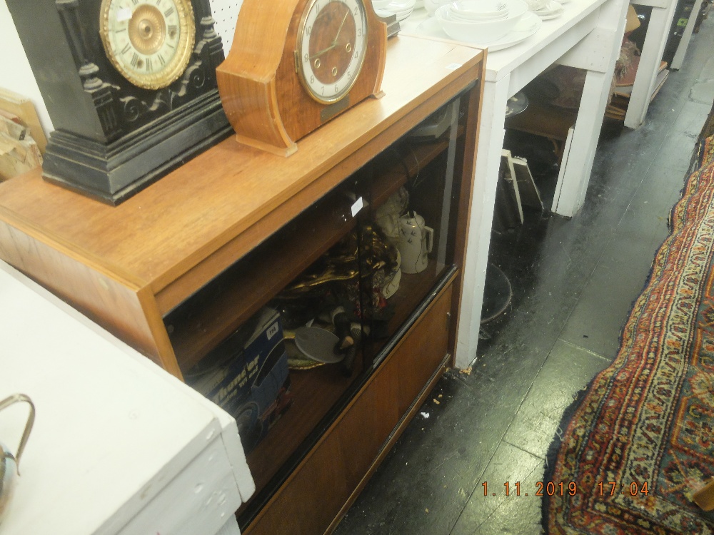 A teak cabinet with sliding doors