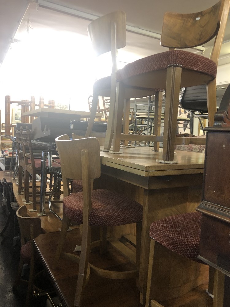 A walnut draw leaf table and six chairs