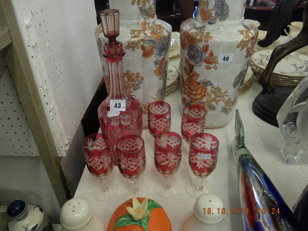 A cranberry glass decanter and six glasses