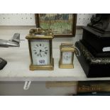 Two brass carriage clocks with keys,