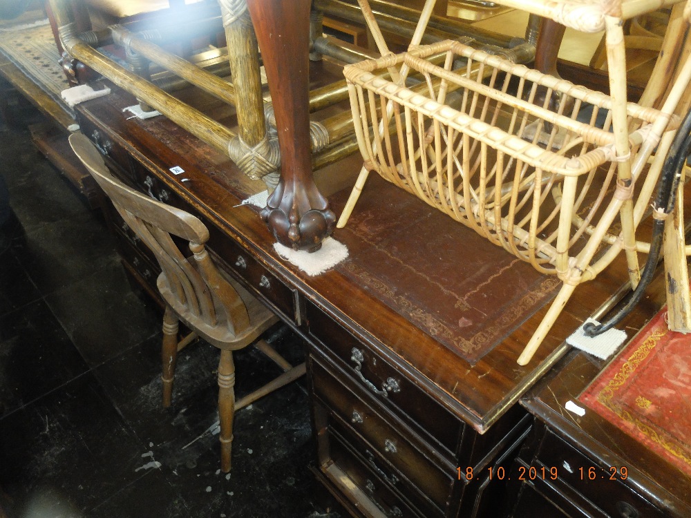 A large mahogany leather top pedestal desk