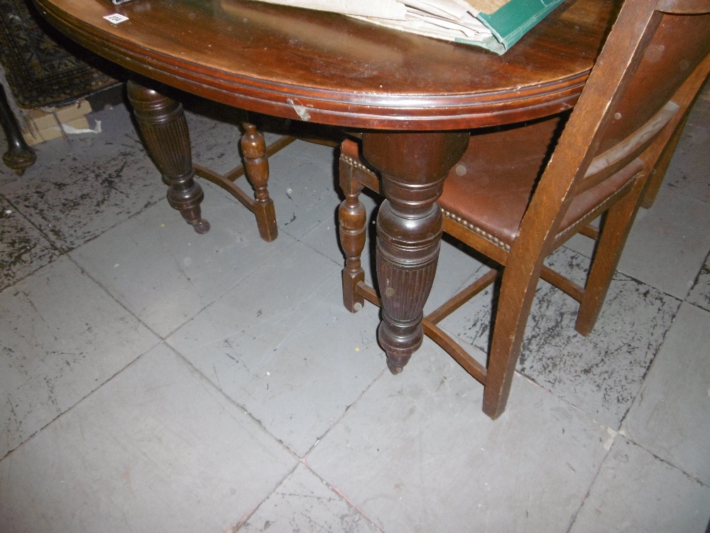 A VICTORIAN EXTENDING TABLE ON TURNED LEGS