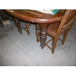 A VICTORIAN EXTENDING TABLE ON TURNED LEGS