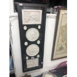 A framed set of classical plaques