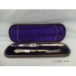 A boxed Victorian hallmarked silver bread knife and fork