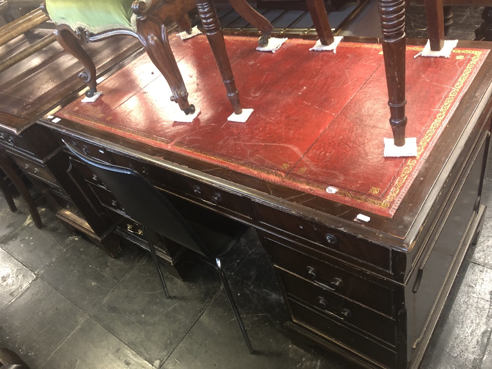 A pedestal desk red leather top