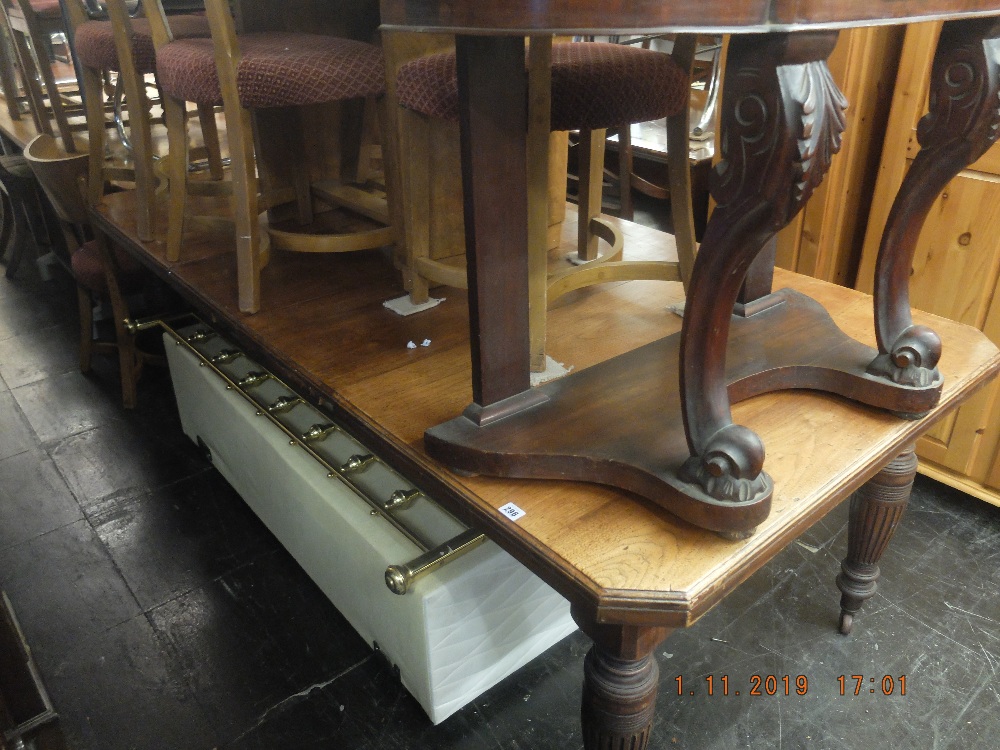 A mahogany extending table with two extra leaves