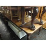 A mahogany extending table with two extra leaves