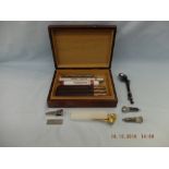 A mahogany cigar box with six cigars (Romeo y Julieta and King Edwards) plus five cigar cutters and