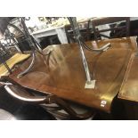 A contemporary extending dining table with two leaves,