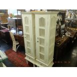 A pair of white louvre door cabinets