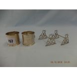 Two hallmarked silver napkin rings and silver knife rests