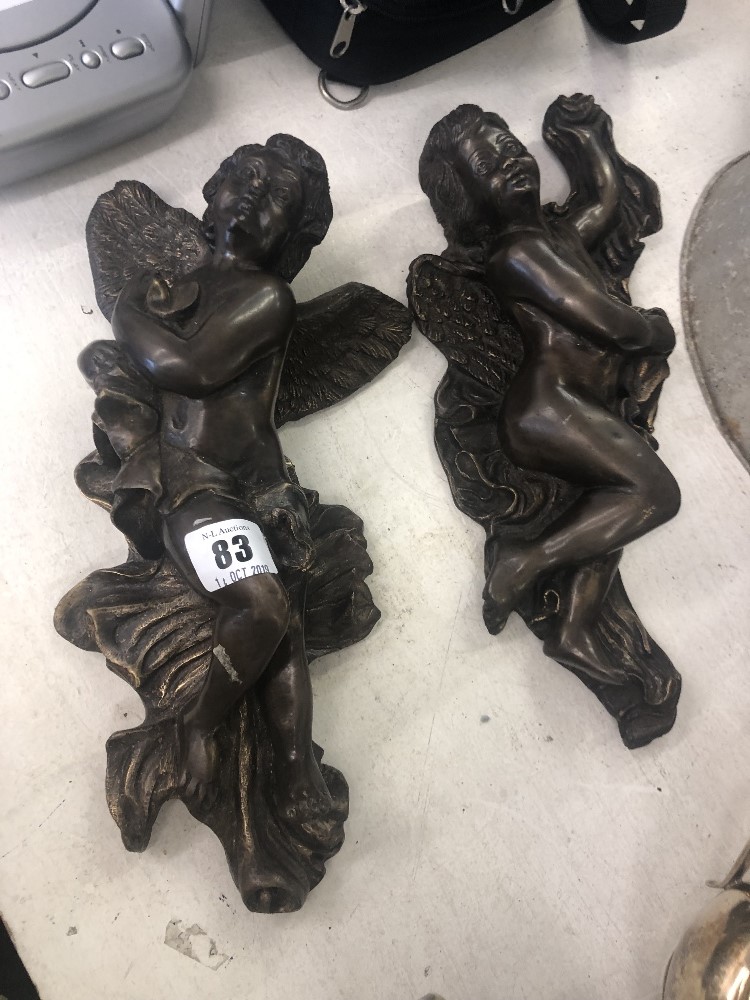 A pair of bronze wall cherubs