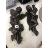 A pair of bronze wall cherubs