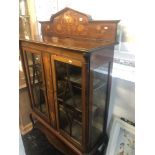 An inlaid mahogany art nouveau two door display cabinet