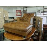 A brown leather armchair and stool by John Lewis