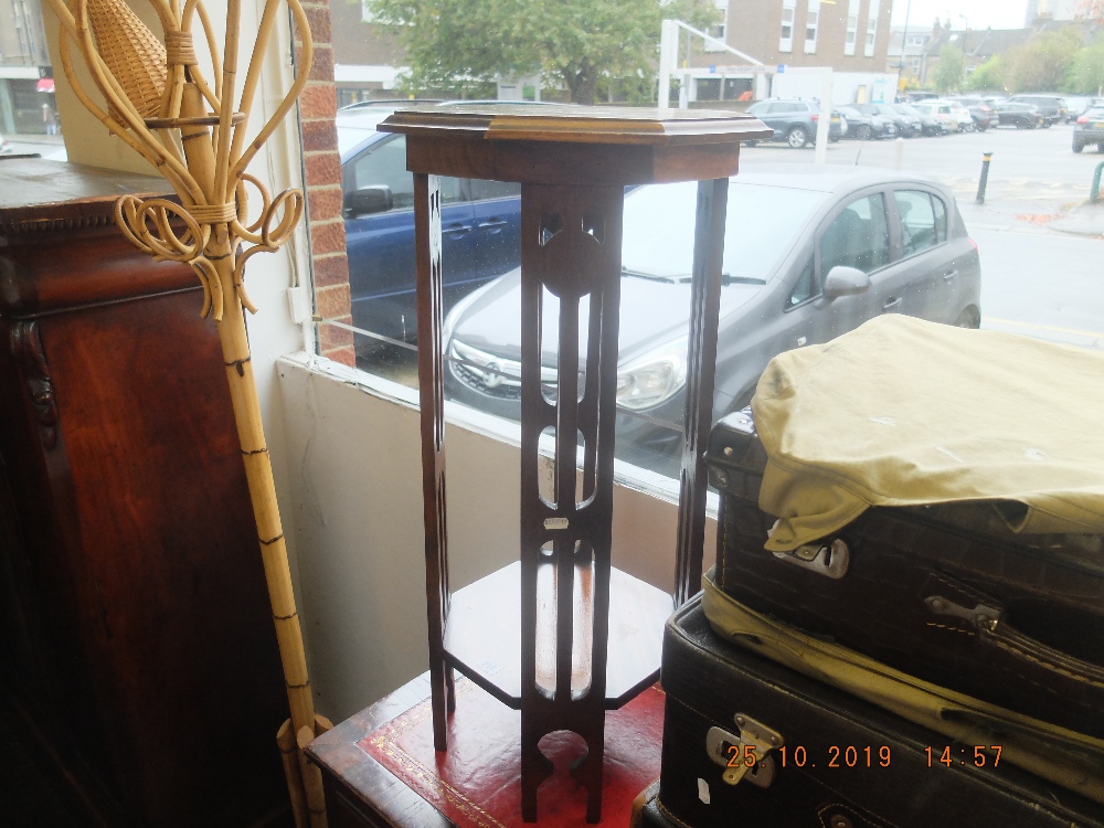 A mahogany art and crafts plant stand