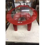 A red retro style coffee table with red edged glass