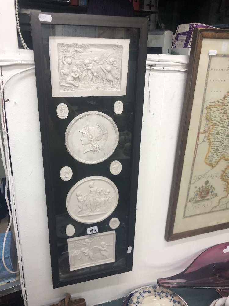 A framed set of classical plaques