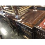 A large mahogany leather top pedestal desk