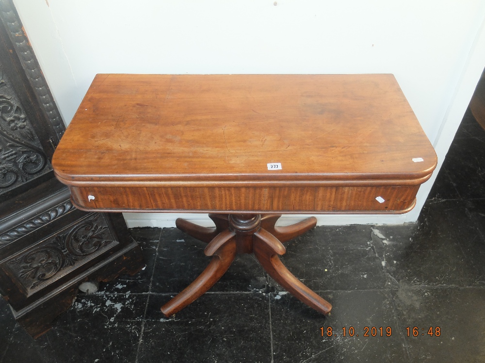 A 19th century fold over mahogany tea table