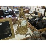 A gilt mantle clock surmounted with huntsman