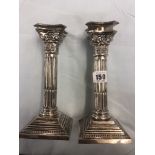 A pair of cast corinthumn column hm silver candlesticks Birmingham 1932 weight 490 grams