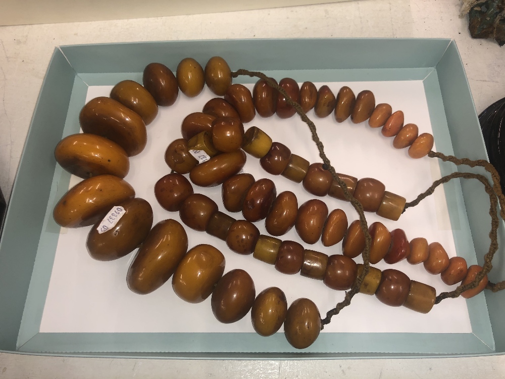 Three giant amber-like resin necklaces,