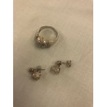 An 18ct white gold and diamond cluster ring with matching earrings