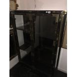 An oriental black lacquered display cabinet